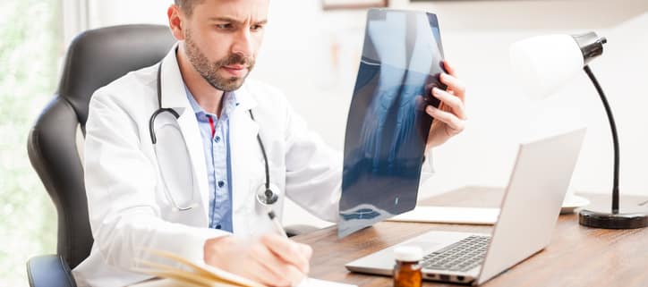 Handsome orthopedist busy at work - Colorado Center of Orthopaedic Excellence Orthopedist vs Rheumatologist