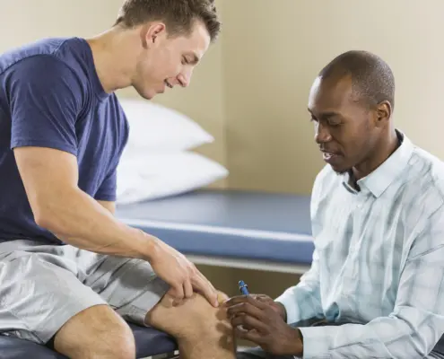 Physical therapist examining patient