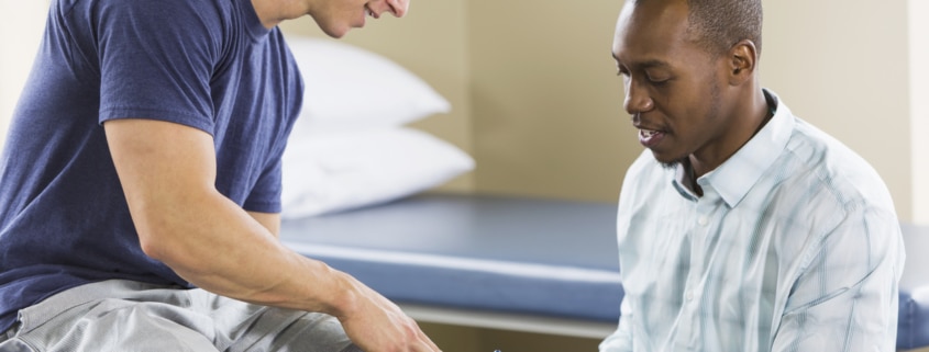 Physical therapist examining patient