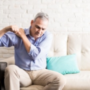 Mature man with shoulder pain at home