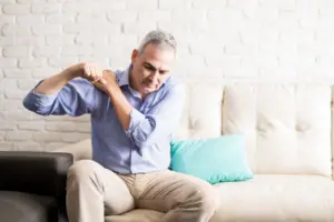 Mature man with shoulder pain at home